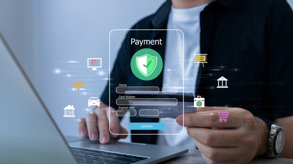A person using a laptop to make an online payment, with a virtual payment form and security icons overlaid, symbolizing secure digital transactions and e-commerce.